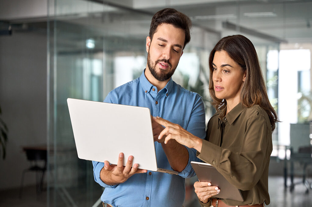 Two coworkers exemplifying adaptability as they discuss changing business plans