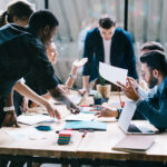A group of young entrepreneurs shares ideas at a table